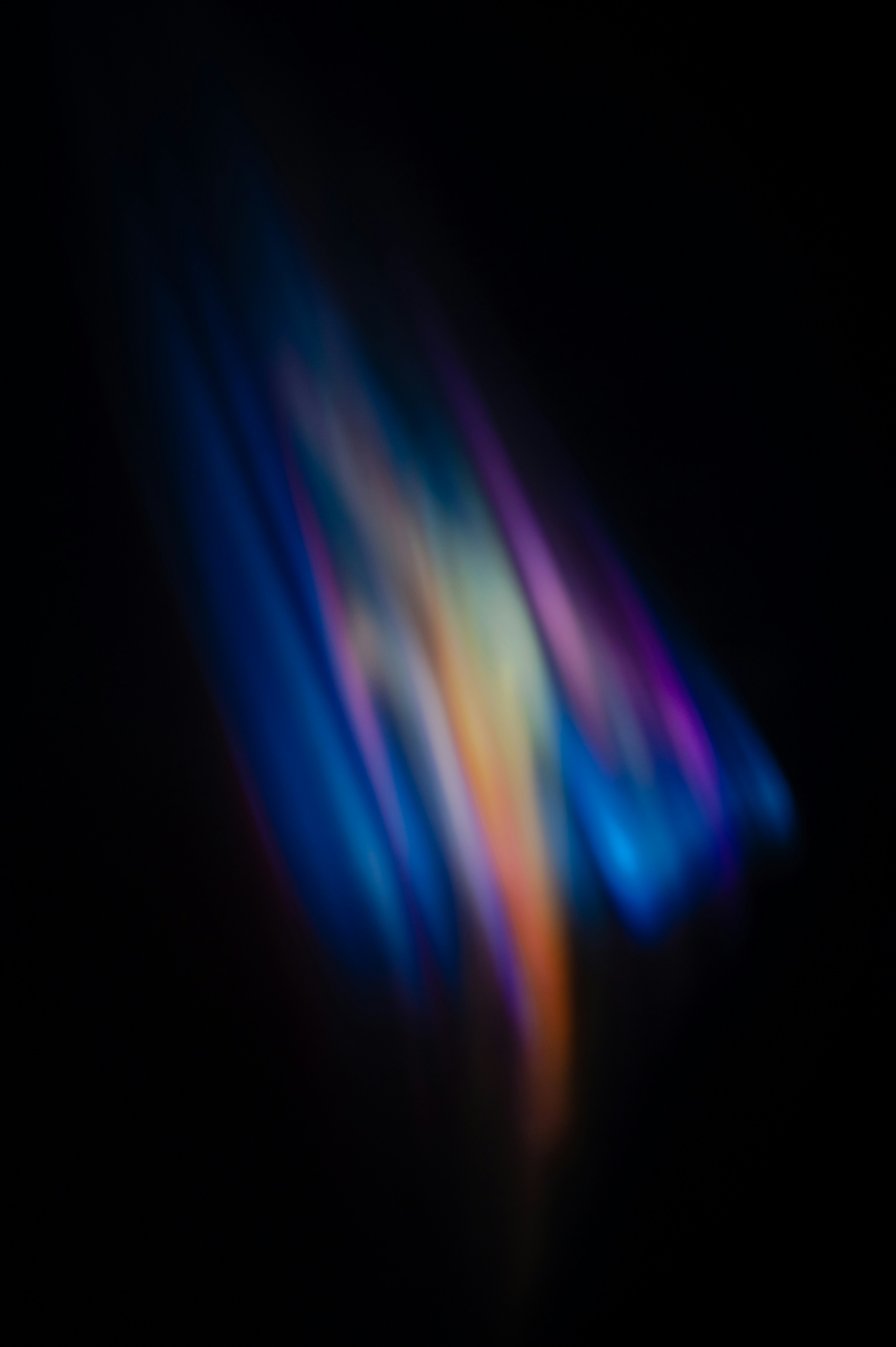 Soft blue, violet and gold light against black