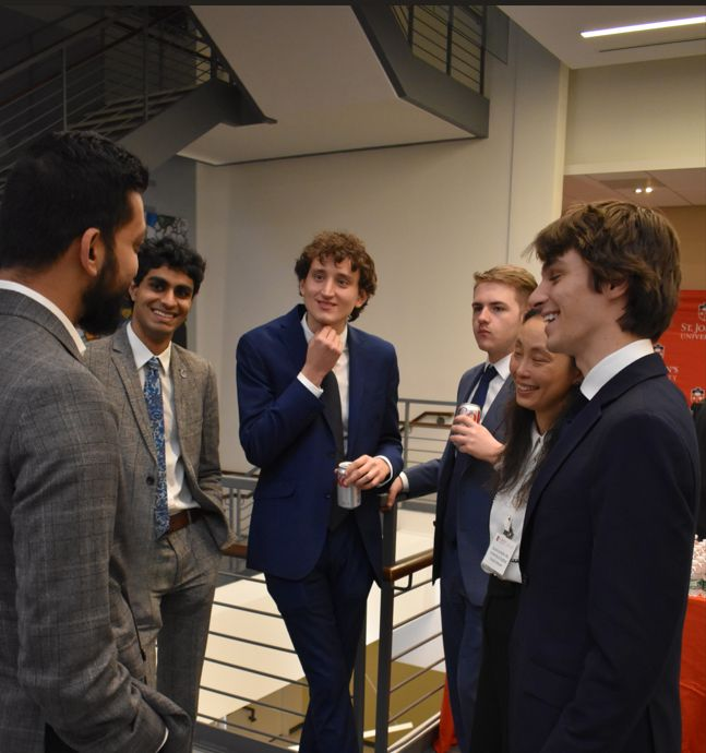 Team members in conversation at the competition